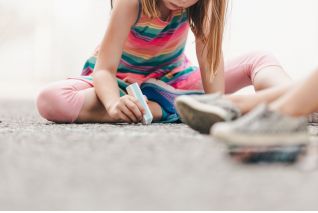 little-girl-drawing-with-chalk-on-ground