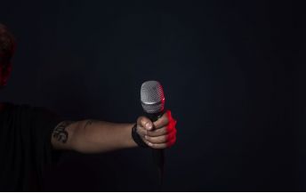 singer-on-stage-holds-mic